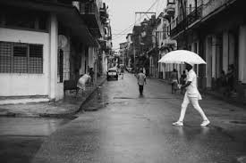 people walking in rain in urban setting